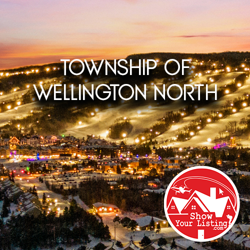 Stunning aerial view of Wellington North showcasing homes, community amenities, and recreational activities, perfect for real estate listings and virtual tours showcasing small-town charm.